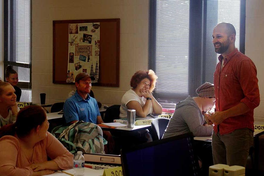 Nate Maddux teaches in a class full of students.