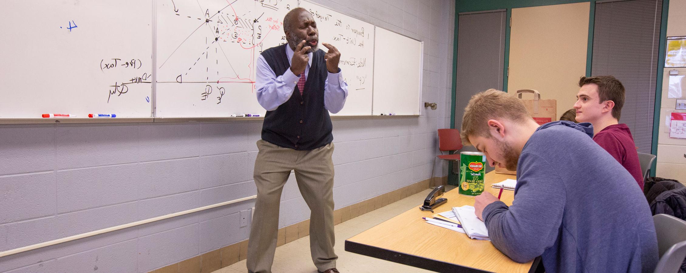 George Jones teaching at a whiteboard.